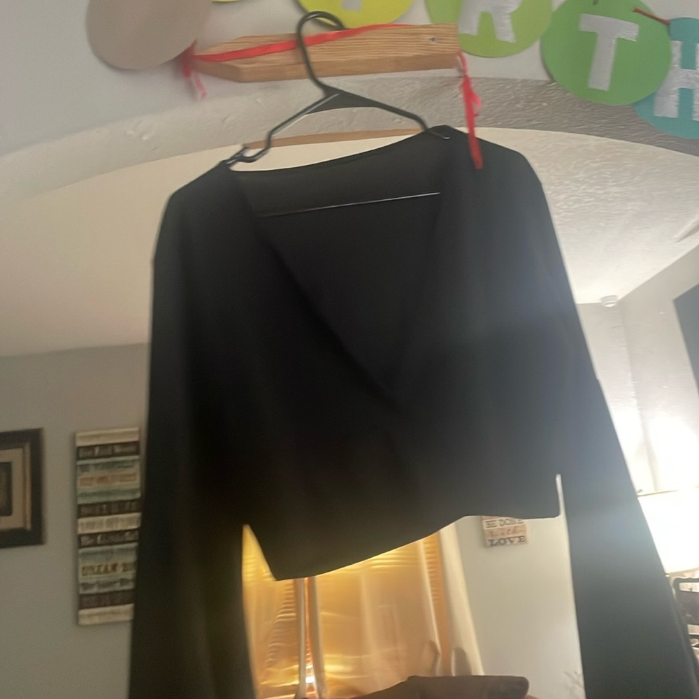 This is a black crop top with long, flustered sleeves from SHEIN .